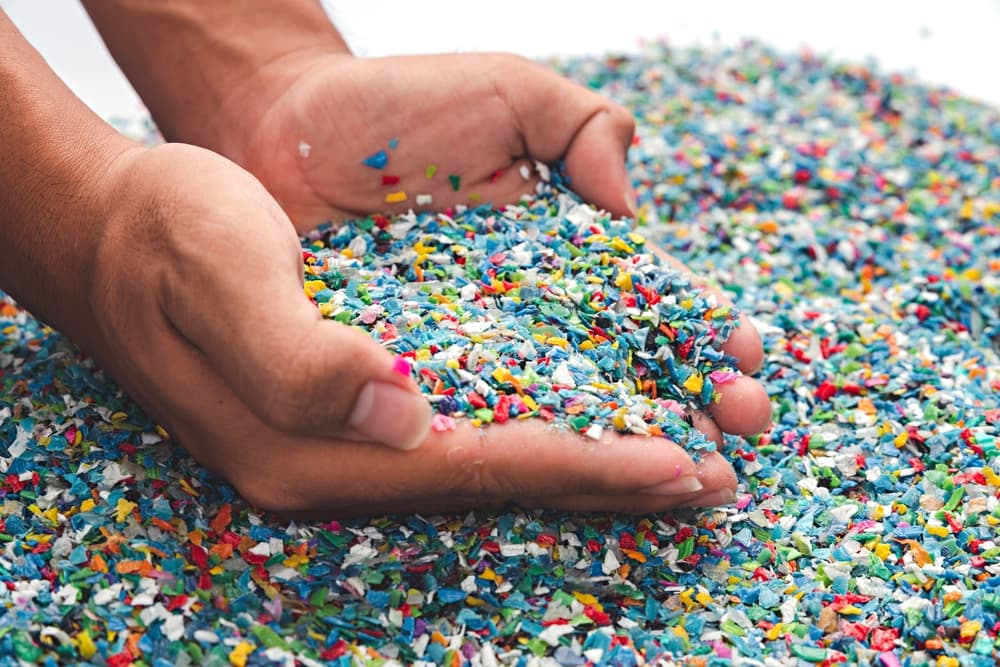 person-holding-recycled-plastic-pellets